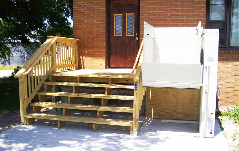 Home wooden porch steps with lift attached to the right side